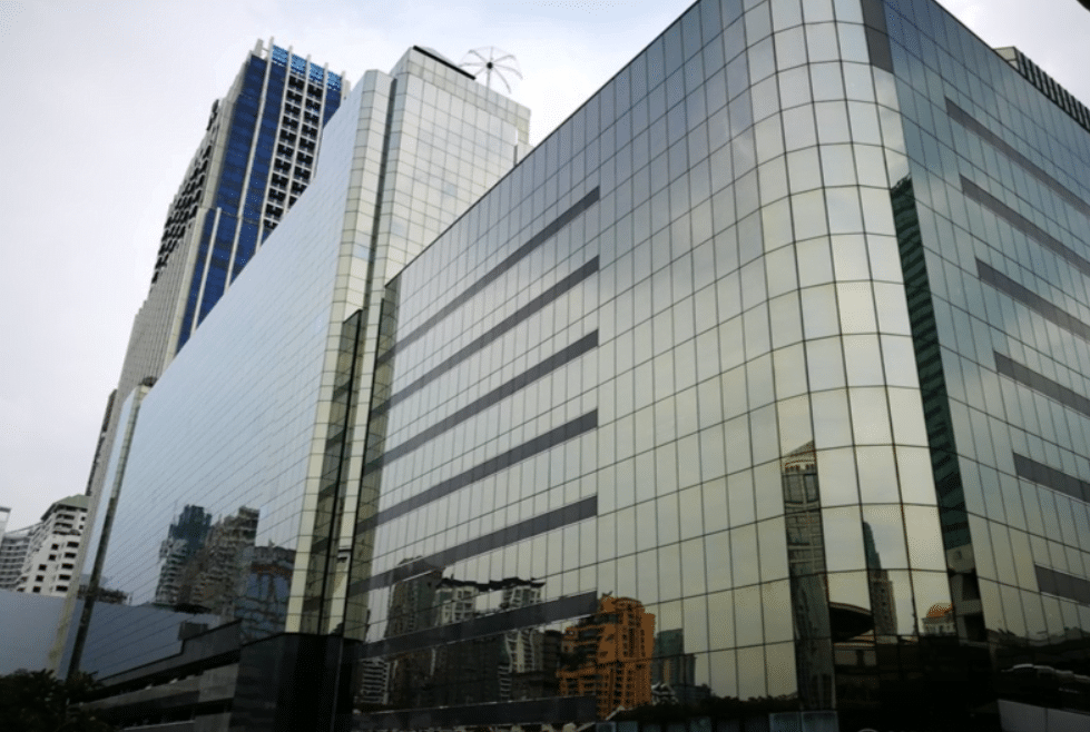 Choosing the Right Financial Software: ERP vs. Accounting Software 1 A modern cityscape featuring a series of tall, glass-clad skyscrapers with reflective surfaces. The buildings mirror the surrounding urban environment, including other high-rise structures and parts of the skyline, against a partly cloudy sky. It’s all about capturing the essence of urban life.