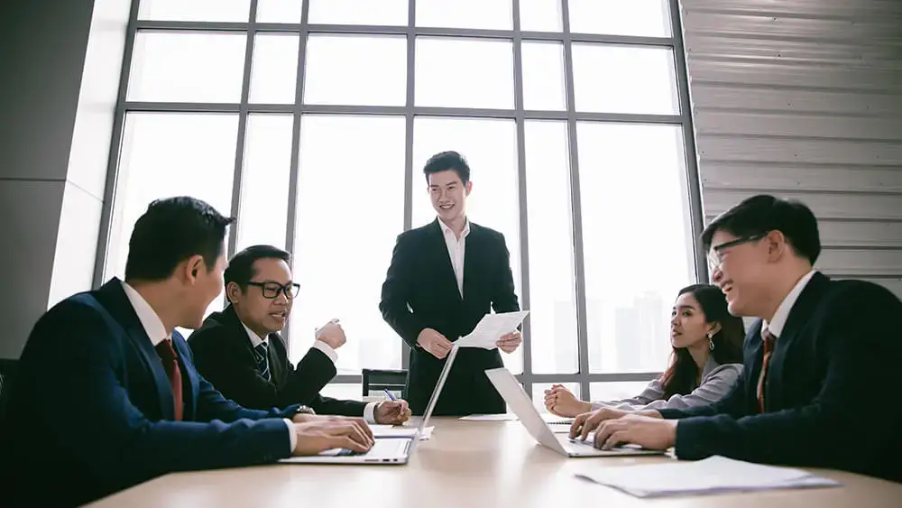 Company Registration in Thailand: Expert Guidance and Avoiding Common Pitfalls 2 Company Registration in Thailand with completed with Ease and Speed AO 2024 Businessman giving presentation. And other member sitting on chair. Corporate Services in thailand
