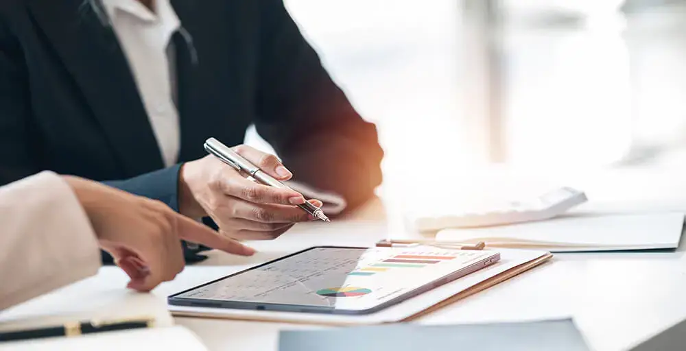 Why Does Your SME Need a Management Accountant instead of a Statutory Accountant in Thailand? 1 a person doing finance Need for a Management Accountant on his table.