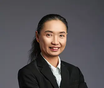 Visa and Work Permit Corporate Secretarial A Picture of woman standing in front of grey background wall.