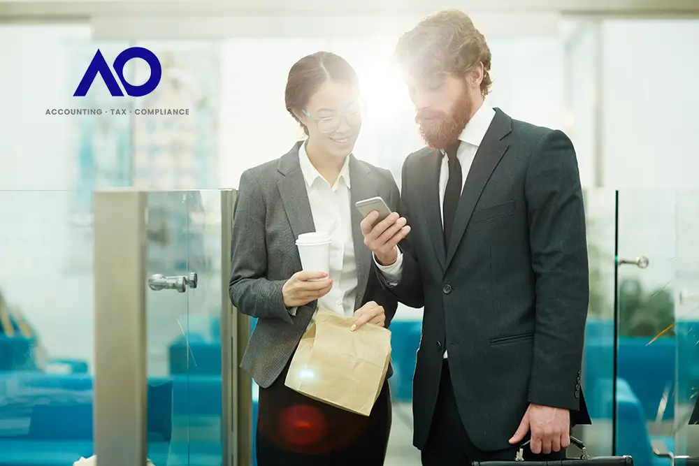 Employee Welfare Fund EWF Ginger man in business suit with beard with young women reading a phone