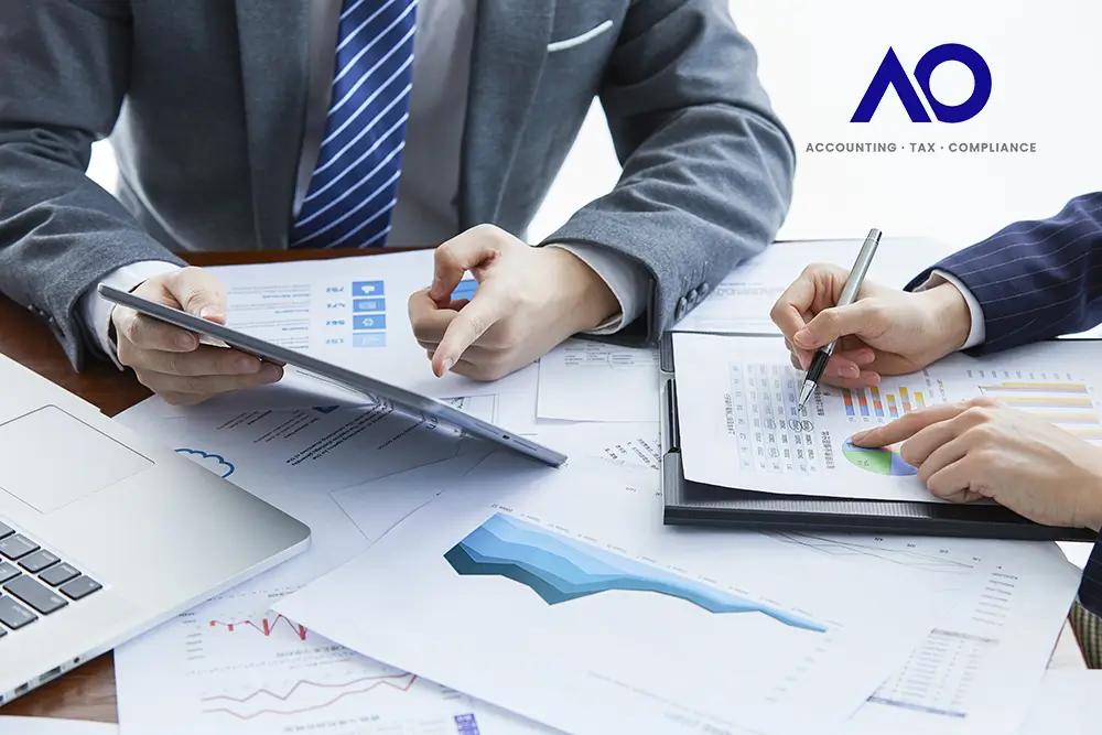 Need For a Management Accountant Man in grey business suit holding a tablet device